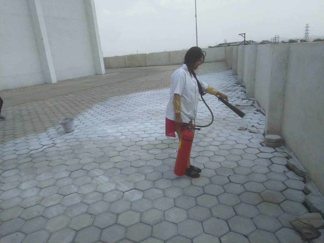 ECOTECH Industries Production and Warehouse staff member, Ms Poonam Dole learns how to use a fire extinguisher correctly as part of regular fire safe